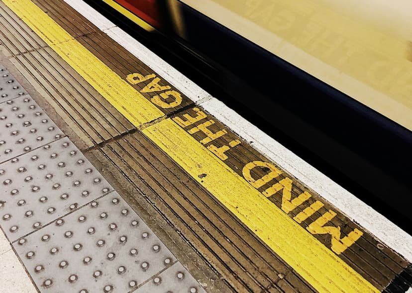 A photo of the London Underground floor that says 'MIND THE GAP'.