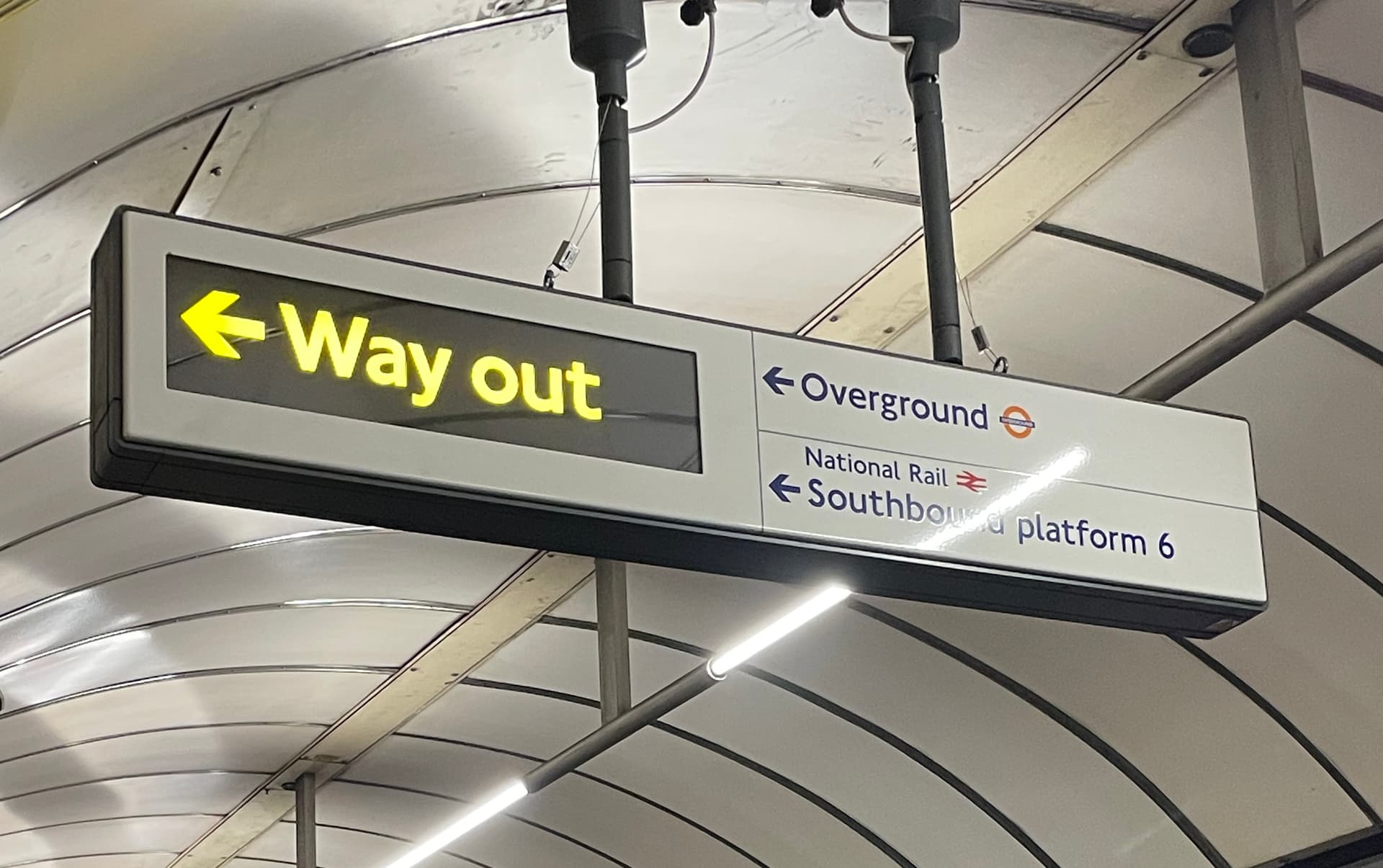 A sign from london underground that says 'WAY OUT'.
